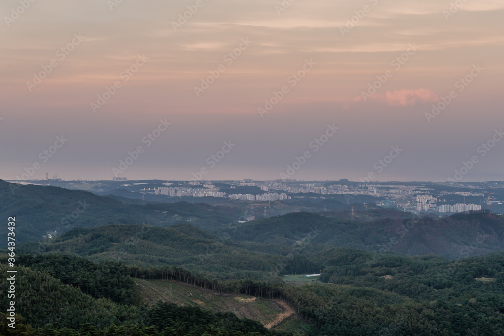 Large city on coast from mountain overlook Large city on coast from mountain overlook