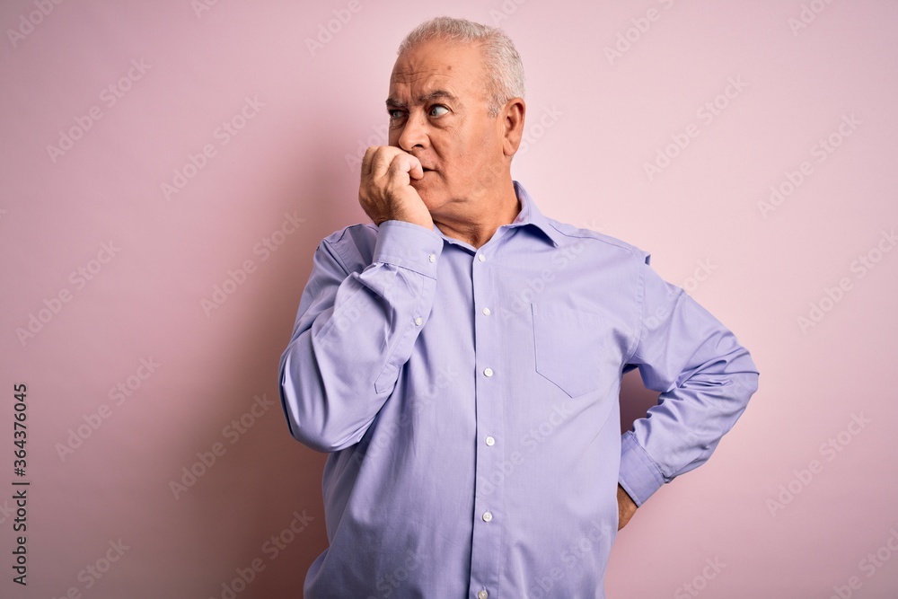 Middle age handsome hoary man wearing casual shirt standing over pink background looking stressed and nervous with hands on mouth biting nails. Anxiety problem. Middle age handsome hoary man wearing casual shirt standing over pink background looking stressed and nervous with hands on mouth biting nails. Anxiety problem.