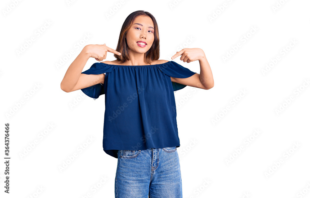 Young beautiful chinese girl wearing casual clothes looking confident with smile on face, pointing oneself with fingers proud and happy. Young beautiful chinese girl wearing casual clothes looking confident with smile on face, pointing oneself with fingers proud and happy.