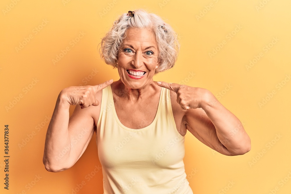 Senior grey-haired woman wearing casual clothes smiling cheerful showing and pointing with fingers teeth and mouth. dental health concept. Senior grey-haired woman wearing casual clothes smiling cheerful showing and pointing with fingers teeth and mouth. dental health concept.