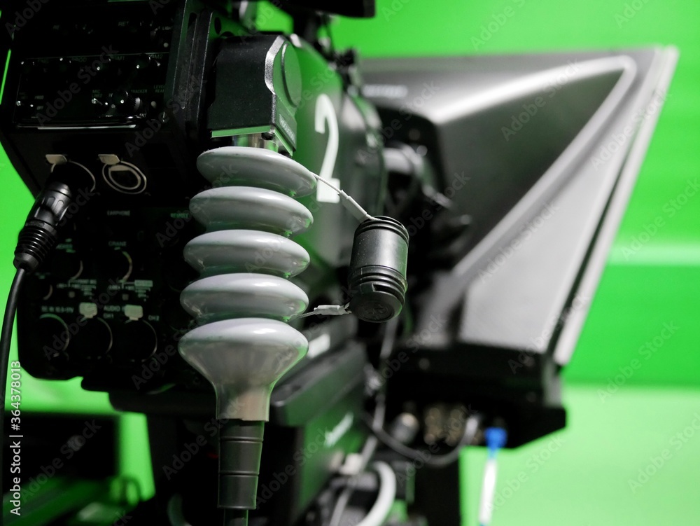 closeup of broadcast television studio camera with greenscreen at TV station. closeup of broadcast television studio camera with greenscreen at TV station.