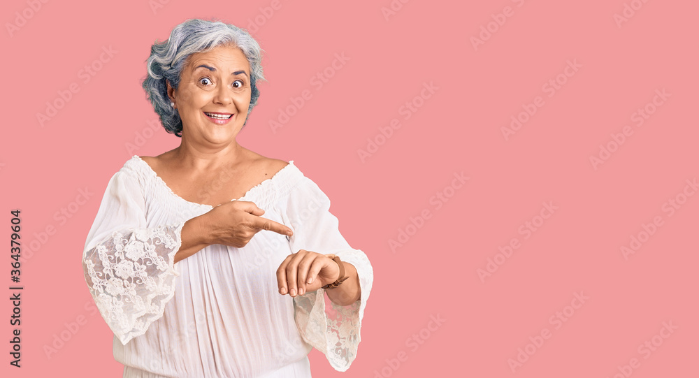 Senior woman with gray hair wearing bohemian style in hurry pointing to watch time, impatience, upset and angry for deadline delay