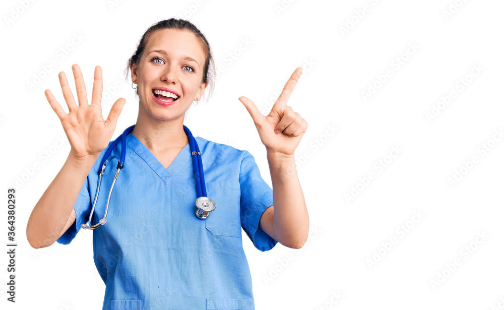 Young beautiful blonde woman wearing doctor uniform and stethoscope showing and pointing up with fingers number seven while smiling confident and happy. Young beautiful blonde woman wearing doctor uniform and stethoscope showing and pointing up with fingers number seven while smiling confident and happy.