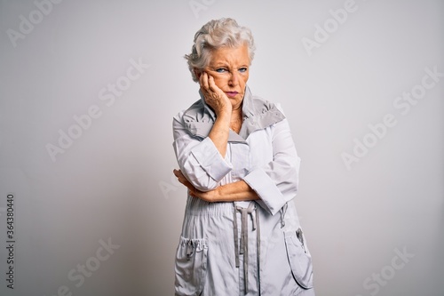 Senior beautiful grey-haired woman wearing casual jacket standing over white background thinking looking tired and bored with depression problems with crossed arms.