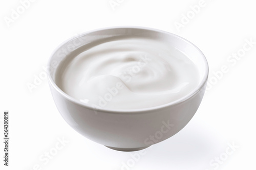 Sour cream yogurt in white bowl isolated on white background.