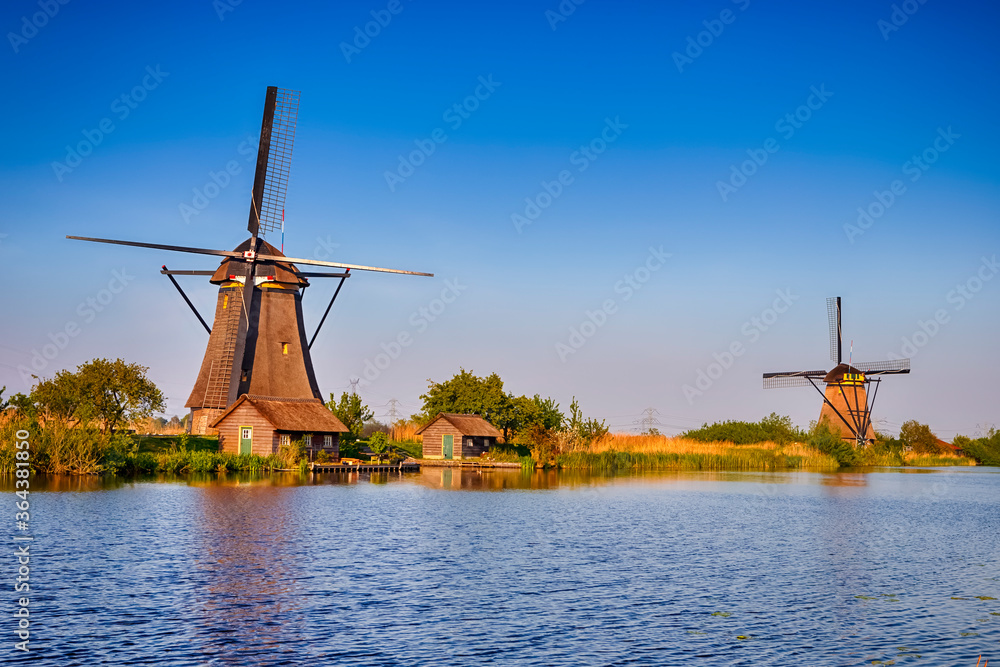 Netherlands Traveling. Traditional Dutch Windmill and House in Kinderdijk Village in the Netherlands At Daytime.