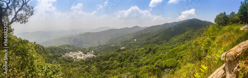 Panorama view of Doi Pui’s Hmong ethnic hill-tribe village, aerial view green forest on the mountain background. Doi Pui Hmong tribal village is located on Doi Suthep-Pui national park, Chiang Mai. © kampwit