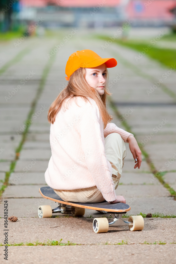 Obraz premium Youth and Teenagers Lifestyle. Portrait of Positive Caucasian Teenager Girl Posing With Longboard in Natural Outdoor Environment.