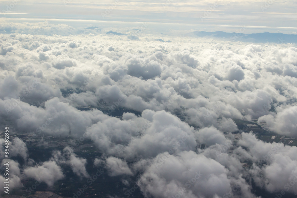 Beautiful cloudscape and blue sky from aerial view, nature view from above the sky and clouds. White clouds and blue sky view like the heaven from airplane window. Sunlight in the sky shines on clouds Beautiful cloudscape and blue sky from aerial view, nature view from above the sky and clouds. White clouds and blue sky view like the heaven from airplane window. Sunlight in the sky shines on clouds