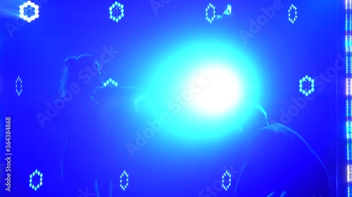 Wallpaper Mural Silhouettes of a talented young girl and boy hip hop dancers. Hip hop street dance on a stage in dark studio with smoke and neon lighting. Dynamic lighting effects. Creative skills. Slow motion. Torontodigital.ca