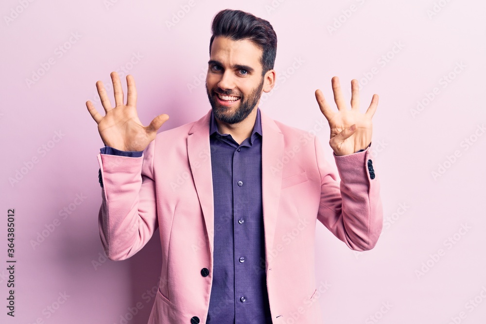 Young handsome man with beard wearing elegant jacket showing and pointing up with fingers number nine while smiling confident and happy. Young handsome man with beard wearing elegant jacket showing and pointing up with fingers number nine while smiling confident and happy.