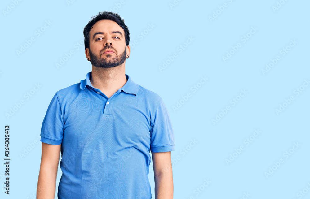 Fototapeta premium Young hispanic man wearing casual clothes relaxed with serious expression on face. simple and natural looking at the camera.