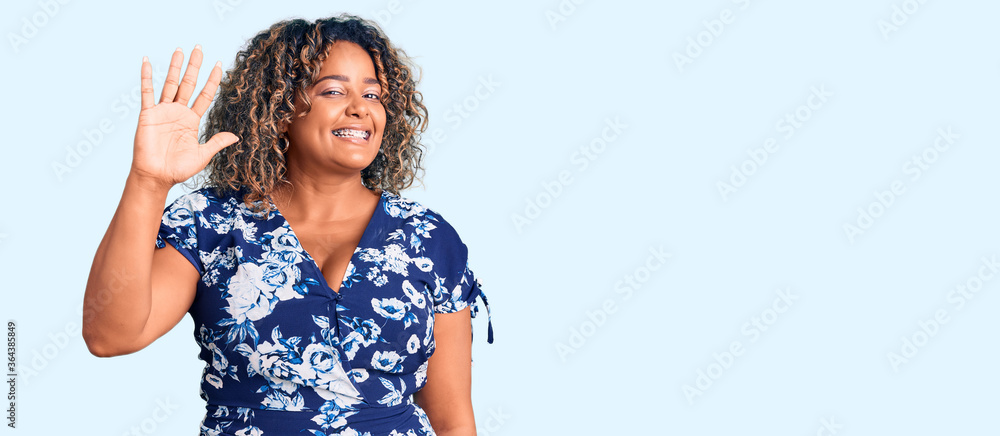 Young african american plus size woman wearing casual clothes showing and pointing up with fingers number five while smiling confident and happy. Young african american plus size woman wearing casual clothes showing and pointing up with fingers number five while smiling confident and happy.