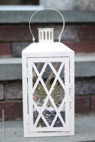 White Lantern on Brick Steps with Fairy Lights