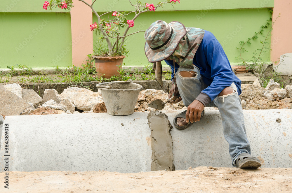 Worker stoppers the leak of pipes by concrete Worker stoppers the leak of pipes by concrete