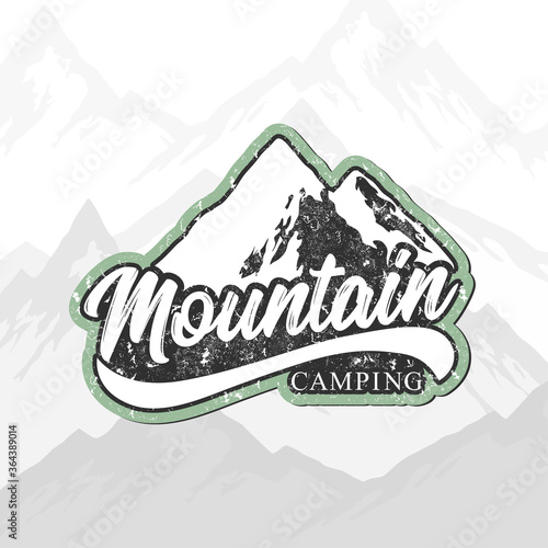 Mountain camping hand drawn vector logo with rocky peaks, lettering and texture isolated on mountain landscape background. Outdoor adventures concept for label, emblem, packaging