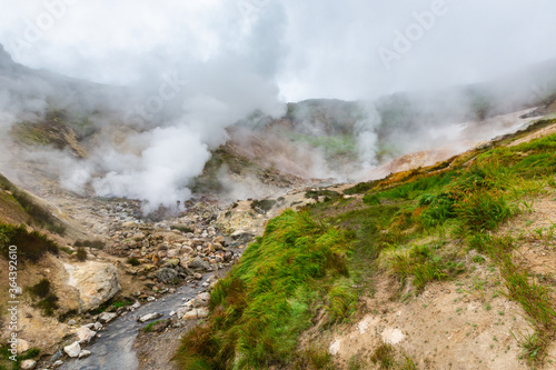 Picturesque view of volcanic landscape, aggressive hot spring, erupting fumarole, gas-steam activity in crater active volcano. Amazing mount landscape, travel destinations for hike, active vacation.