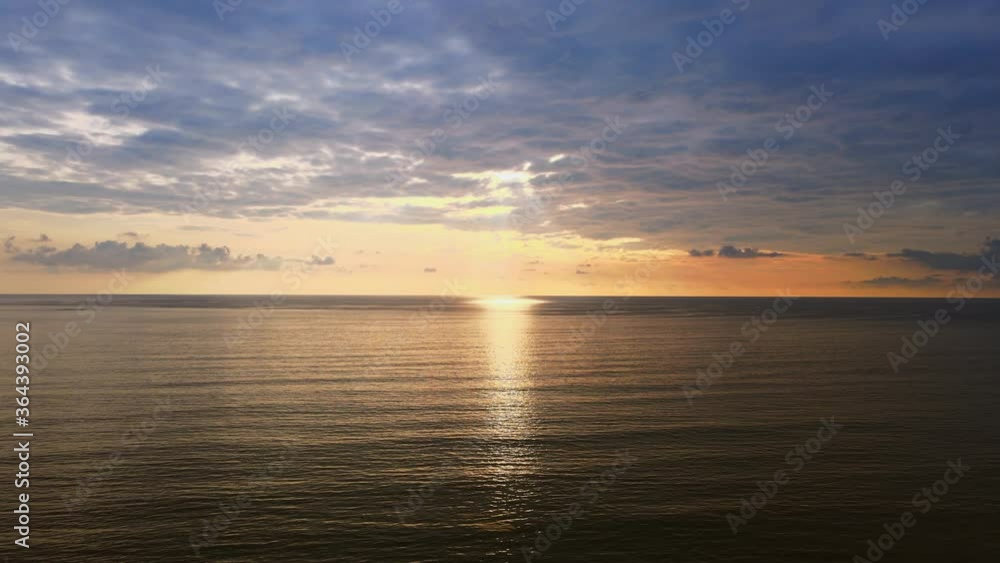4K Aerial view Drone view moving forward over the sea to sunset with clouds and sunlight reflect from sea. Beautiful Phuket beach is famous tourist destination at Andaman sea. 4K Aerial view Drone view moving forward over the sea to sunset with clouds and sunlight reflect from sea. Beautiful Phuket beach is famous tourist destination at Andaman sea.