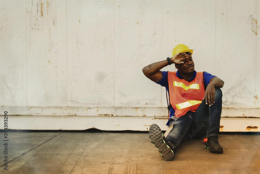 African-American workers sat against a caravan alone, exhausted from overworked, tired during breaks African-American workers sat against a caravan alone, exhausted from overworked, tired during breaks