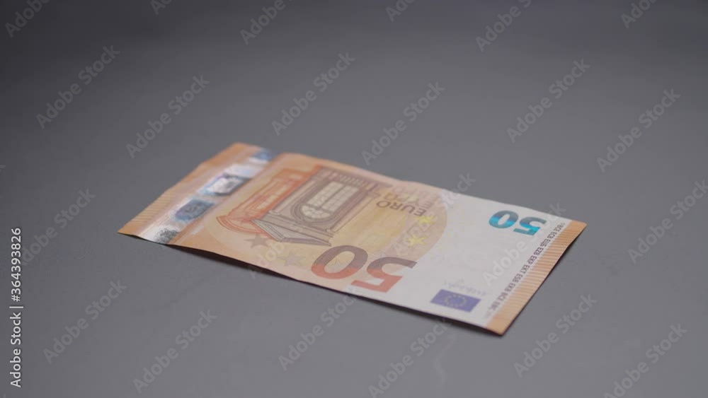 Revealing real Euro banknote under a medical mask ang covering the money again. Revealing real Euro banknote under a medical mask ang covering the money again.