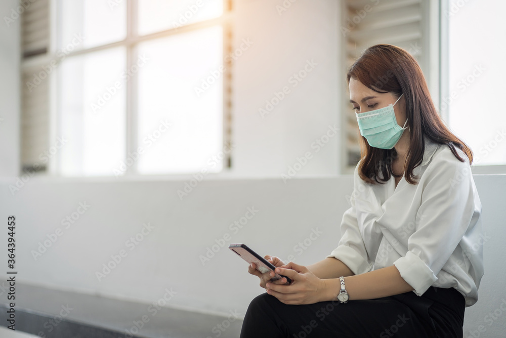 ortrait of a business woman with business suit wears face mask holds morning coffee cup in company building ready for work. A middle age woman with face mask to protect COVID-19 pandemic. stock photo ortrait of a business woman with business suit wears face mask holds morning coffee cup in company building ready for work. A middle age woman with face mask to protect COVID-19 pandemic. stock photo