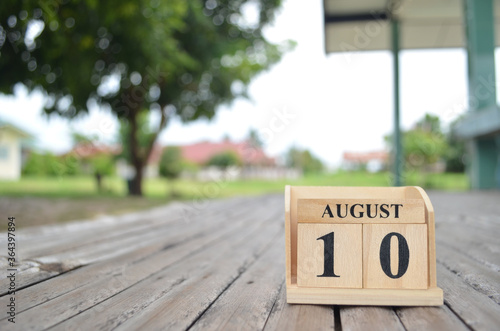 August 10, Number cube with a natural background. photo