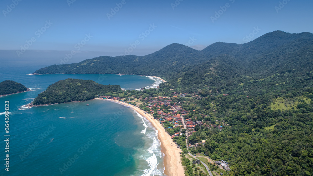 Aerial view to the small beach village Picinguaba, islands and bay, wonderful Green coast landscape in background, Brazil