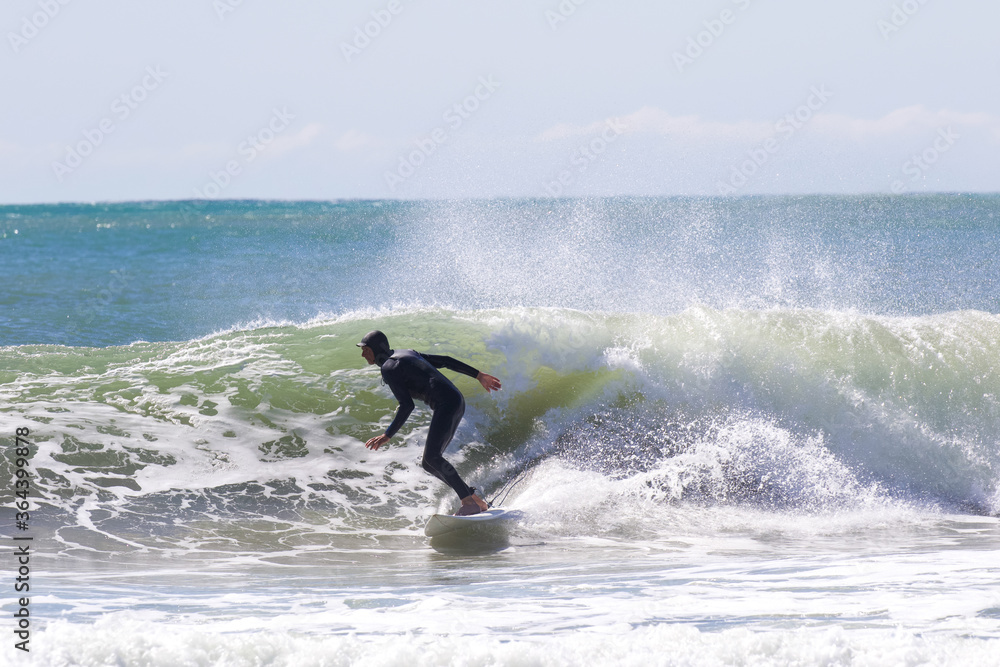 Japan surfing , sometimes during a typhoon, there are many waves in Japan especially in Hebara, Katsuura, Chiba. Westerner surfs large waves. Sunrise & at the beach with a surfer & his surf board. Japan surfing , sometimes during a typhoon, there are many waves in Japan especially in Hebara, Katsuura, Chiba. Westerner surfs large waves. Sunrise & at the beach with a surfer & his surf board.