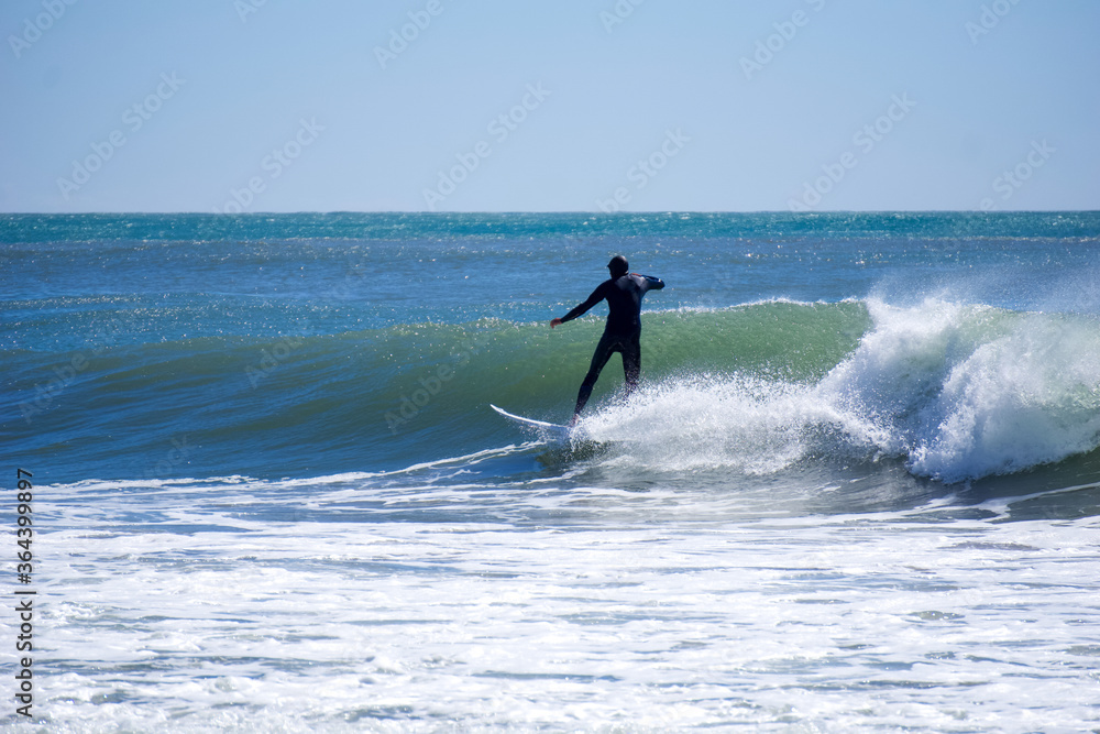 Japan surfing , sometimes during a typhoon, there are many waves in Japan especially in Hebara, Katsuura, Chiba. Westerner surfs large waves. Sunrise & at the beach with a surfer & his surf board. Japan surfing , sometimes during a typhoon, there are many waves in Japan especially in Hebara, Katsuura, Chiba. Westerner surfs large waves. Sunrise & at the beach with a surfer & his surf board.