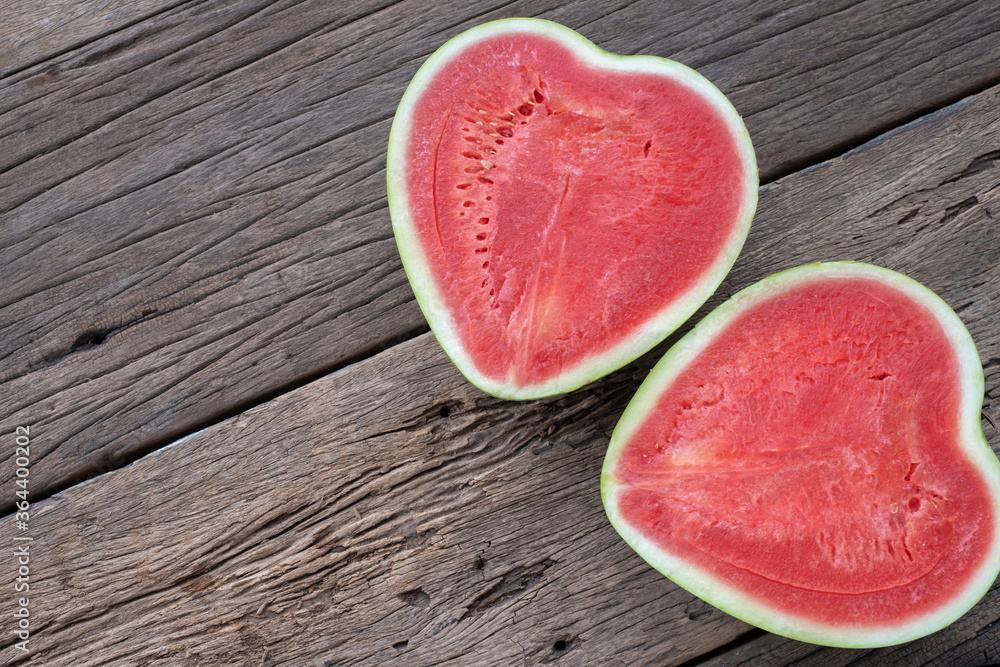 The heart shape of fruit water melon on wood background The heart shape of fruit water melon on wood background