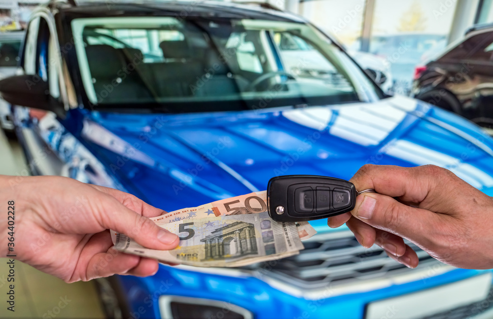 man buy new car giving euro banknotes