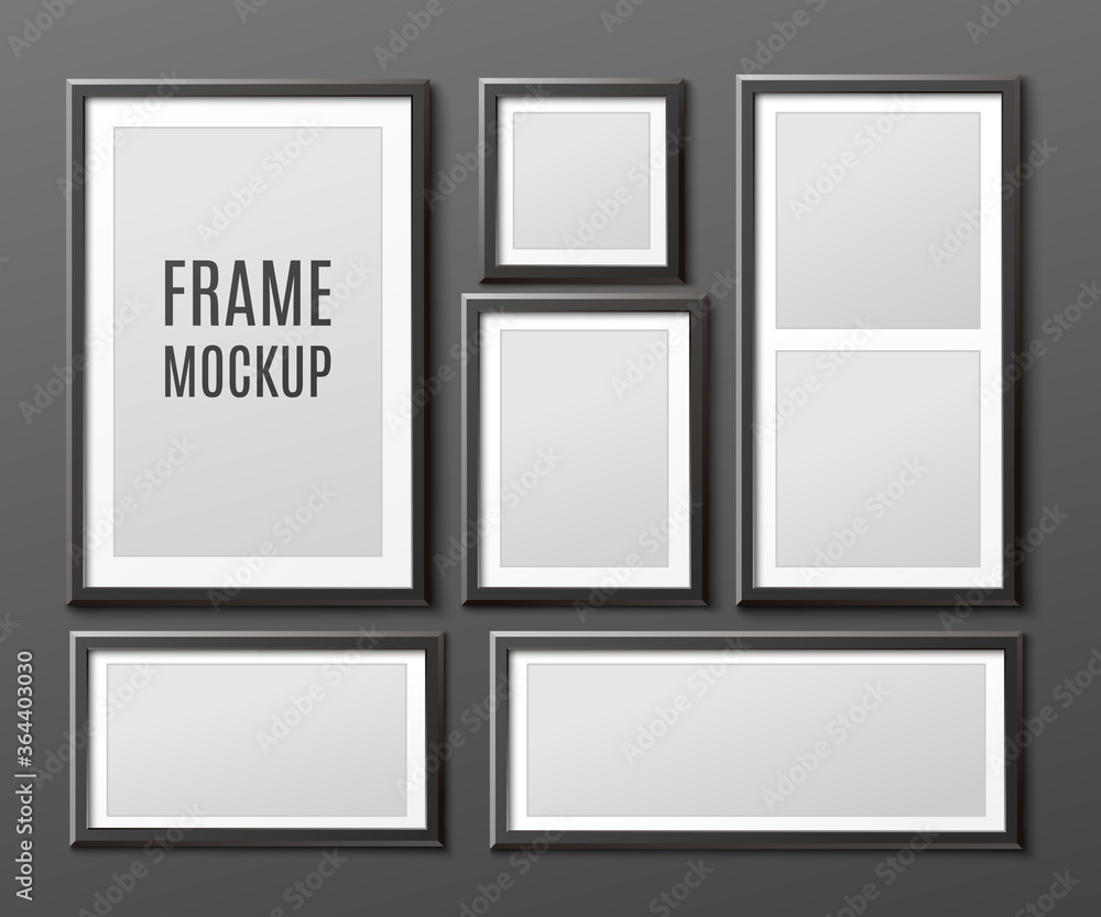 Realistic black photo frame mockup set hanging on dark wall Realistic black photo frame mockup set hanging on dark wall