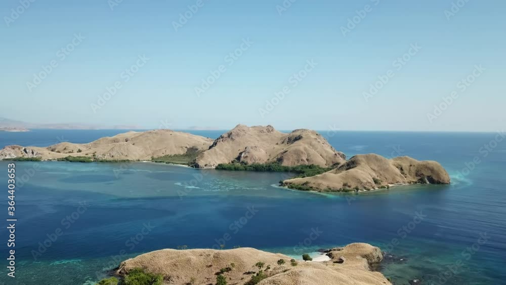 Drone capture of idyllic island formations in Komodo National Park, Indonesia. The islands are surrounded by crystal clear water. Snorkelling spot. Dried land. Flourishing coral reef. Endless horizon
Drone capture of idyllic island formations in Komodo National Park, Indonesia. The islands are surrounded by crystal clear water. Snorkelling spot. Dried land. Flourishing coral reef. Endless horizon
