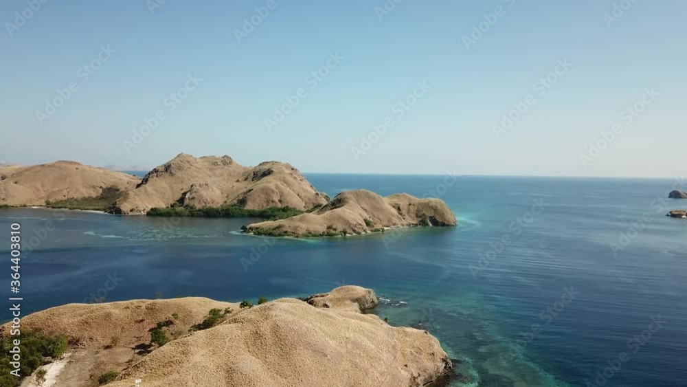Drone capture of idyllic island formations in Komodo National Park, Indonesia. The islands are surrounded by crystal clear water. Snorkelling spot. Dried land. Flourishing coral reef. Endless horizon
Drone capture of idyllic island formations in Komodo National Park, Indonesia. The islands are surrounded by crystal clear water. Snorkelling spot. Dried land. Flourishing coral reef. Endless horizon
