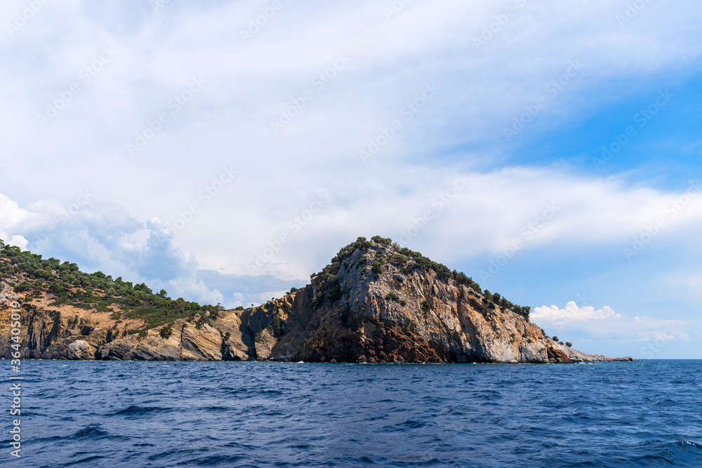 Landscape with sea, the rock and the beautiful clouds in the blue sky Landscape with sea, the rock and the beautiful clouds in the blue sky