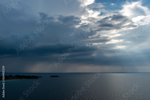 Calm tropical sea under darkening storm storm clouds