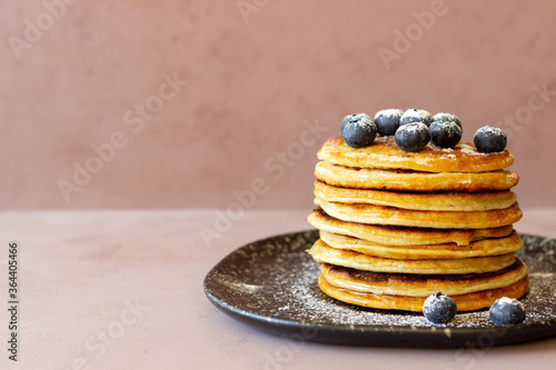 Pancakes with blueberries and honey. Breakfast. Vegetarian food. Recipe.