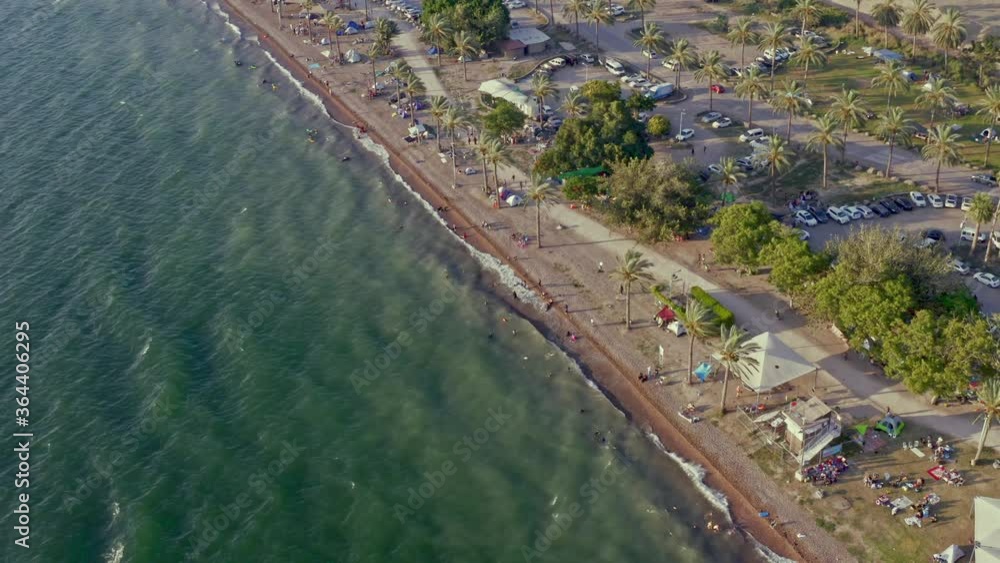 Aerial drone view of a crowded beach and camping on the shore of Kineret, Tiberias, Israel, 4k Aerial drone view of a crowded beach and camping on the shore of Kineret, Tiberias, Israel, 4k