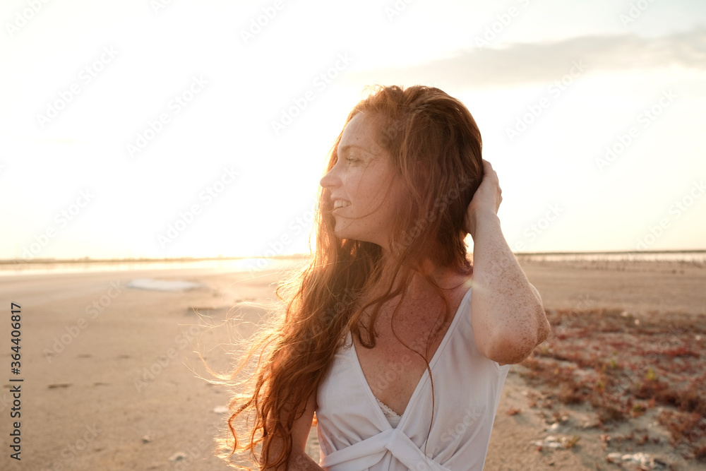 Beautiful young lady with long healthy red hair and cute dress Beautiful young lady with long healthy red hair and cute dress