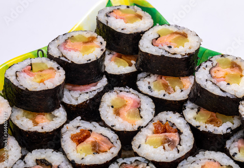 Top view of stack of Japanese sushi maki roll plate. Served in Japanese bar restaurant with chopstick