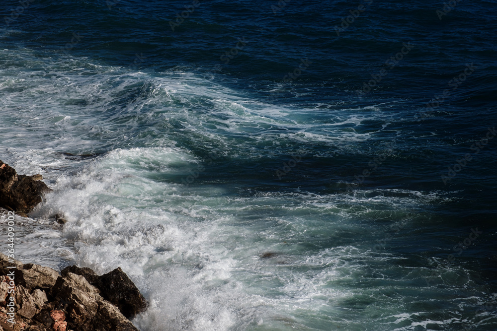 Fototapeta premium Ocean wave background breaking sea water rocky shore