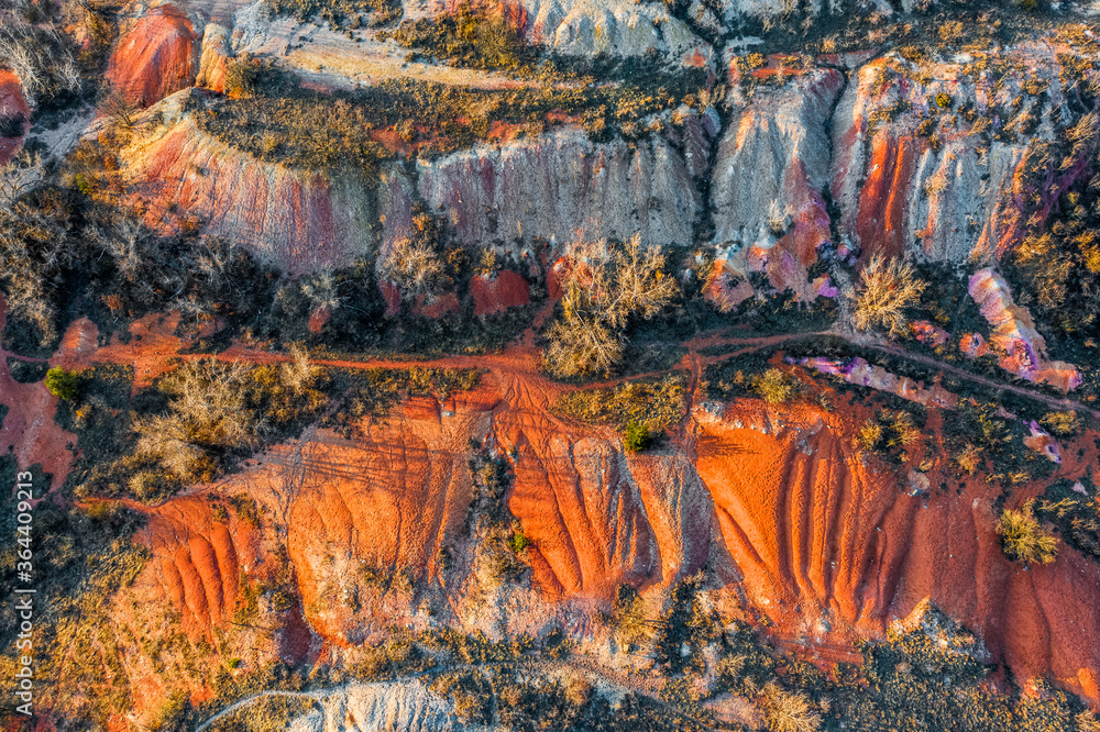 Gant, Hungary - Aerial horizontal drone view of abandoned bauxite mine with  warm red and orange colors and trees at sunset. Red bauxite texture Photos  | Adobe Stock