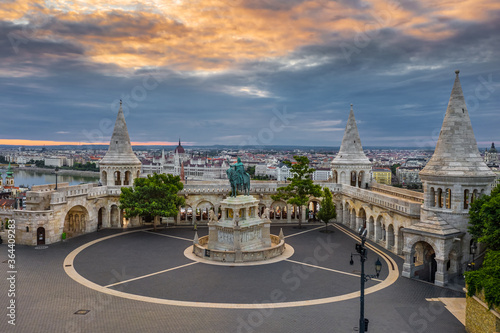 Budapest, Hungary - Aerial drone view of the famous Fisherman's Bastion at sunrise with statue of King Stephen I and Parliament of Hungary at background