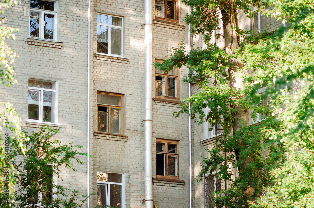 Fototapeta premium Fragment of a 5-storey residential brick house. Typical residential development, Russia.
