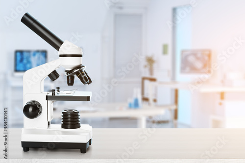 Modern microscope on table ...