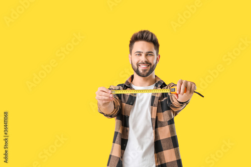 Young man with measuring ta...