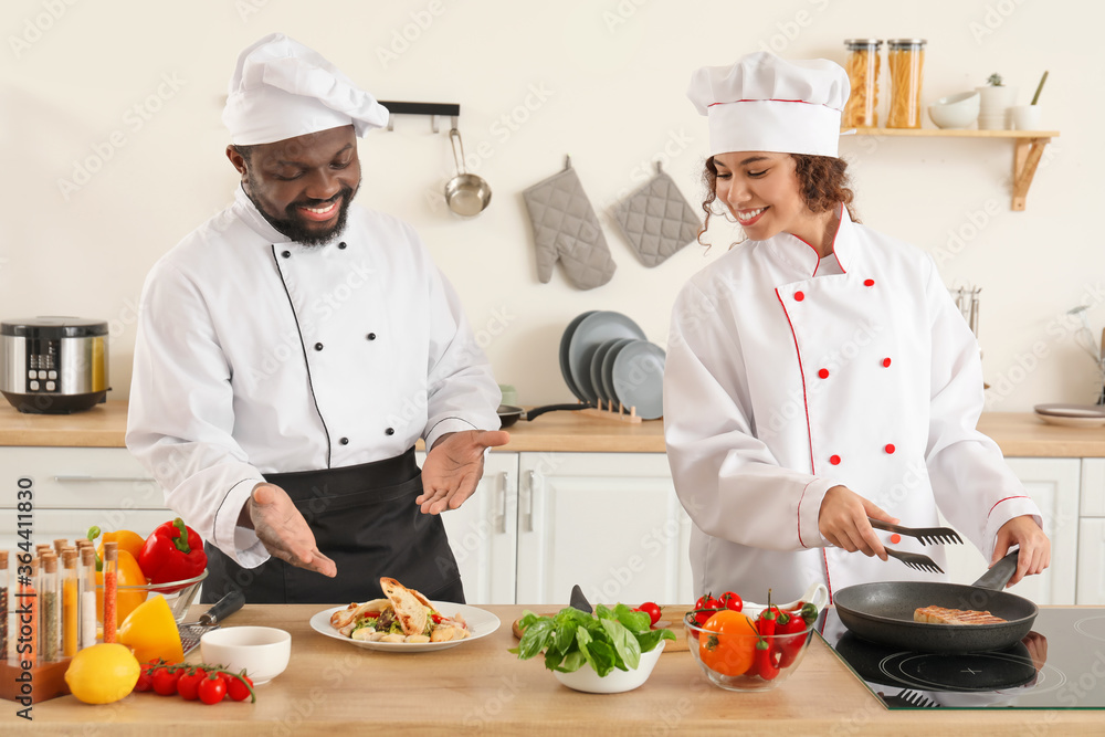 African-American chefs cooking in kitchen