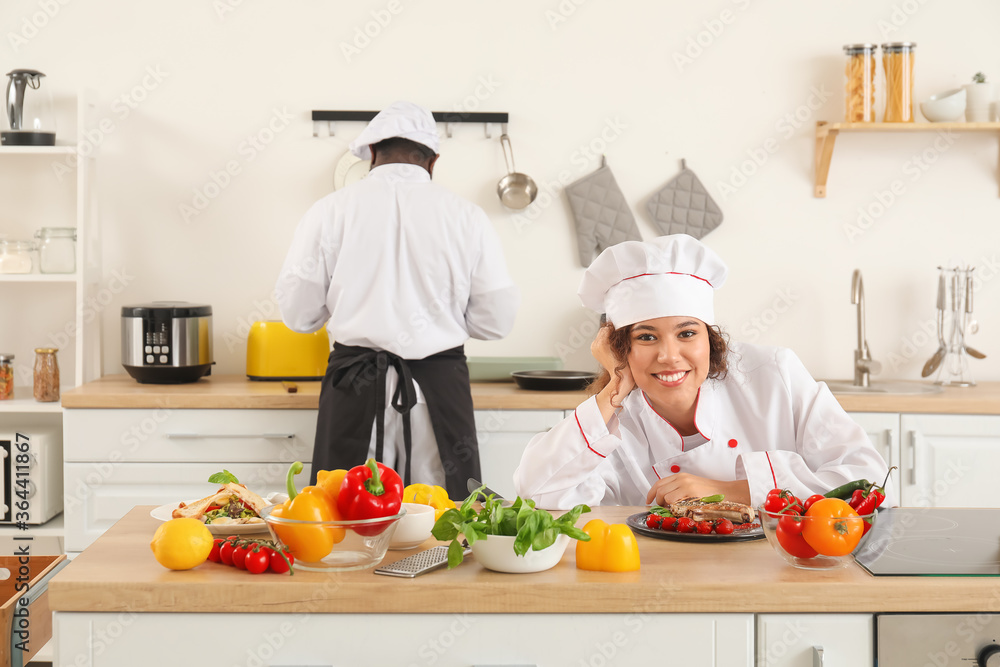 African-American chefs cooking in kitchen African-American chefs cooking in kitchen