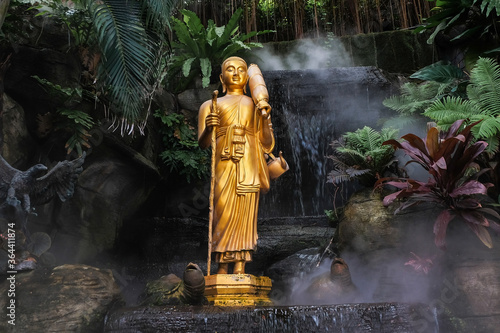 Canvas Print Golden Buddha statue in the tropical garden with waterfall in Wat Saket Golden M