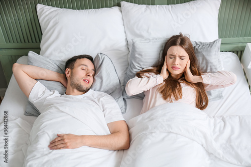 Young irritated woman in be...